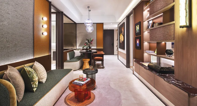 Hudson Place Residences, artist&rsquo;s impression: a living room in dark timber and warm stone, a sofa with cushions, display shelving and the dining area beyond